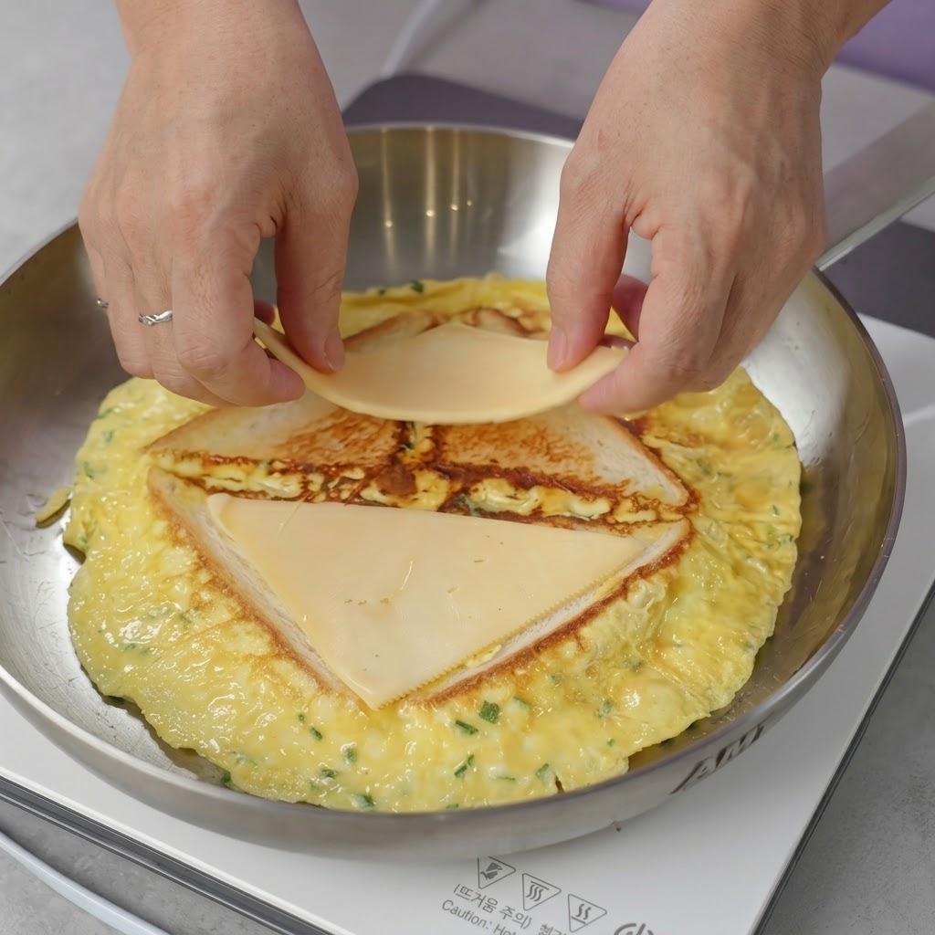 スライスチーズを半分に切り、三角形の食パンの上に1枚ずつのせます。