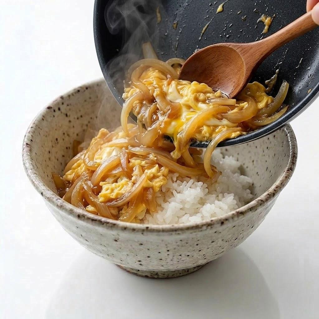 Pour the cooked egg mixture over the rice