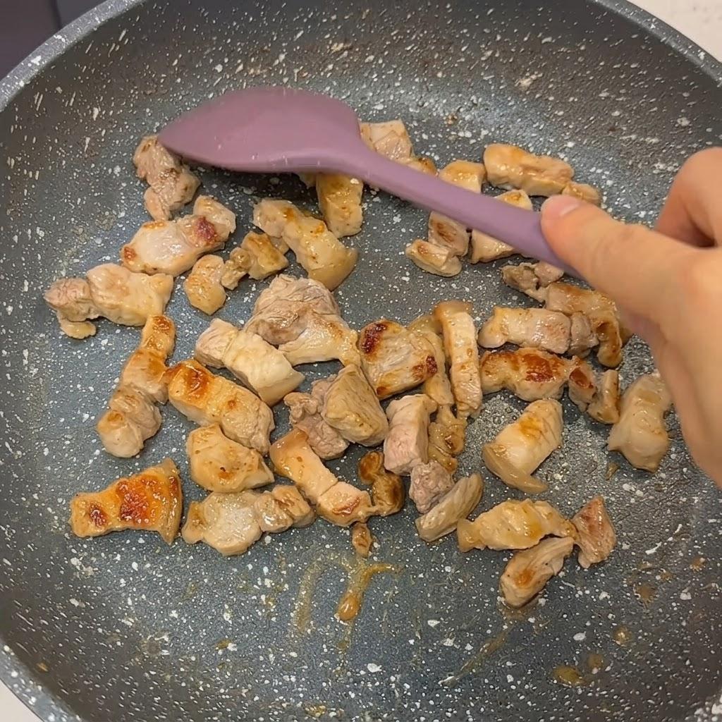 Searing pork belly in pan until golden