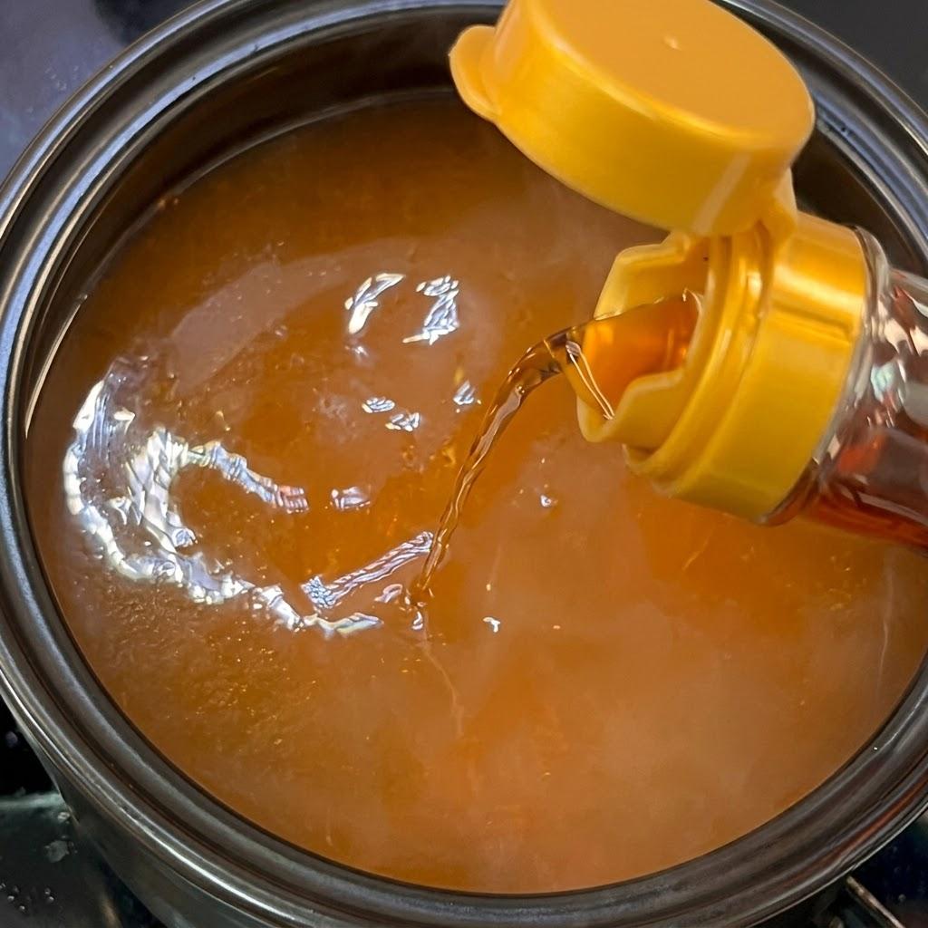 Adding fish sauce to the stew broth