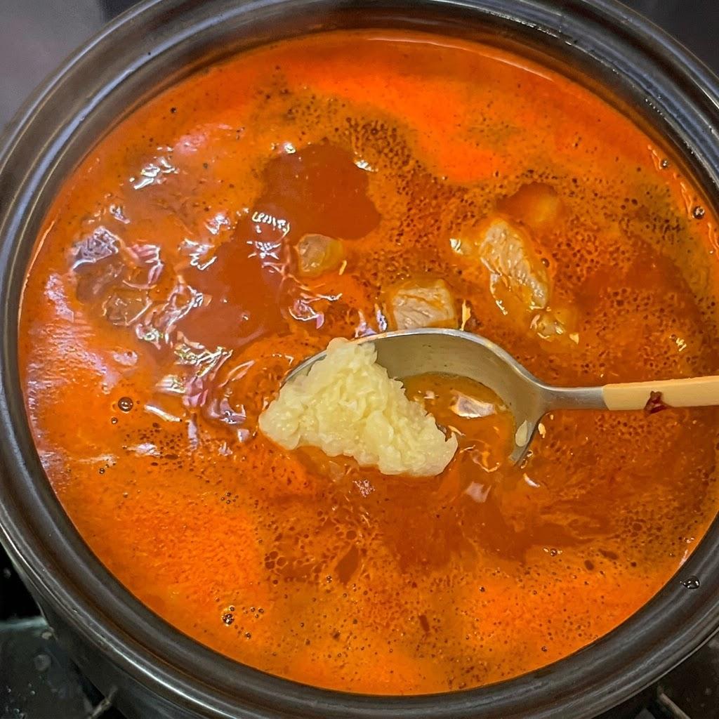 Stirring in fresh minced garlic